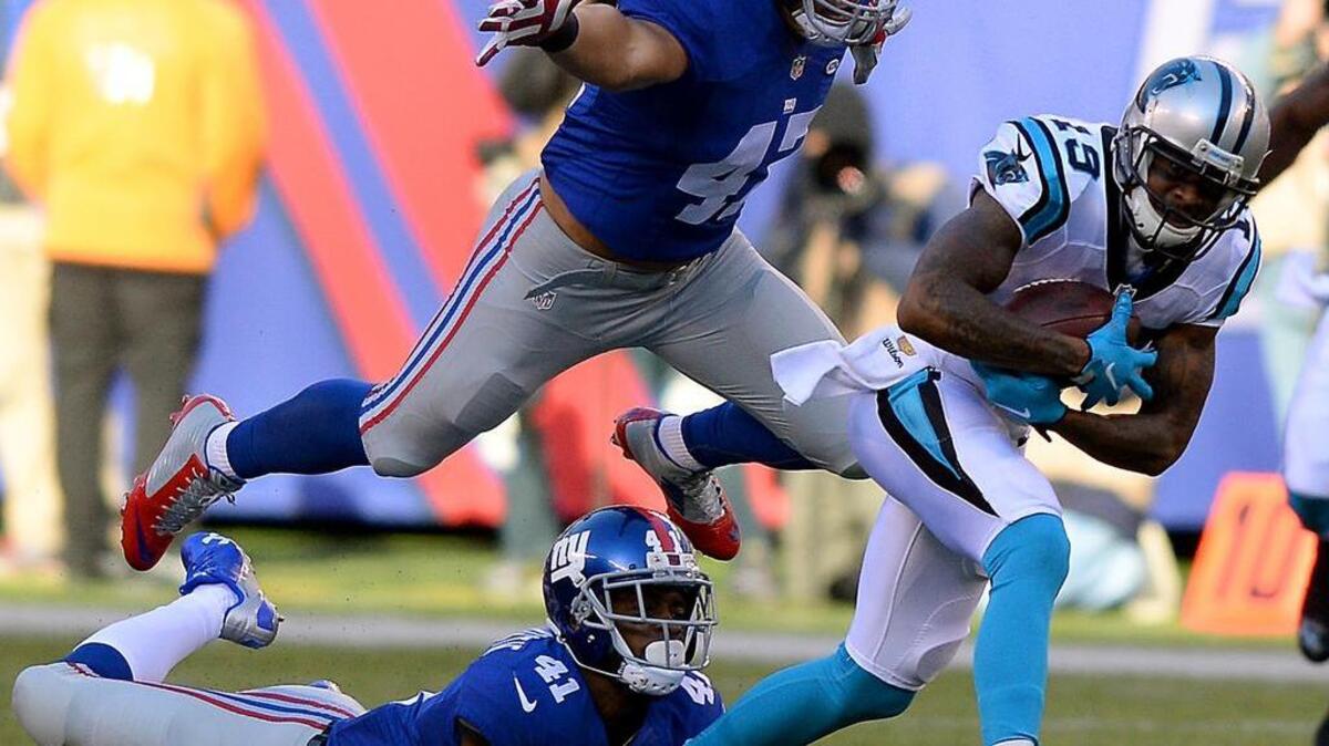 Carolina Panthers wide receiver Ted Ginn Jr., right, said he returned to Sunday’s 38-35 victory over the New York Giants despite sore ribs because he saw his team in a dog fight.