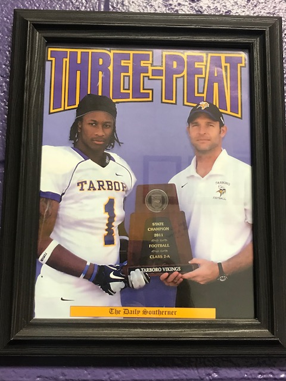 This photo of Tarboro alum Todd Gurley and his head coach, Jeff Craddock, hangs in Craddock’s office at Tarboro high school.