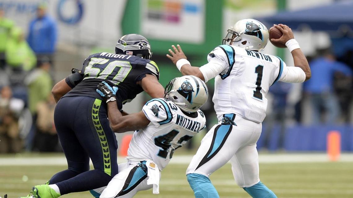 Carolina Panthers' Cam Newton (1) gets protection from Fozzy Whittaker (43) against Seattle Seahawks' K.J. Wright (50) in the second half at CenturyLink Field on Sunday, October 18, 2015. The Panthers won 27-23.