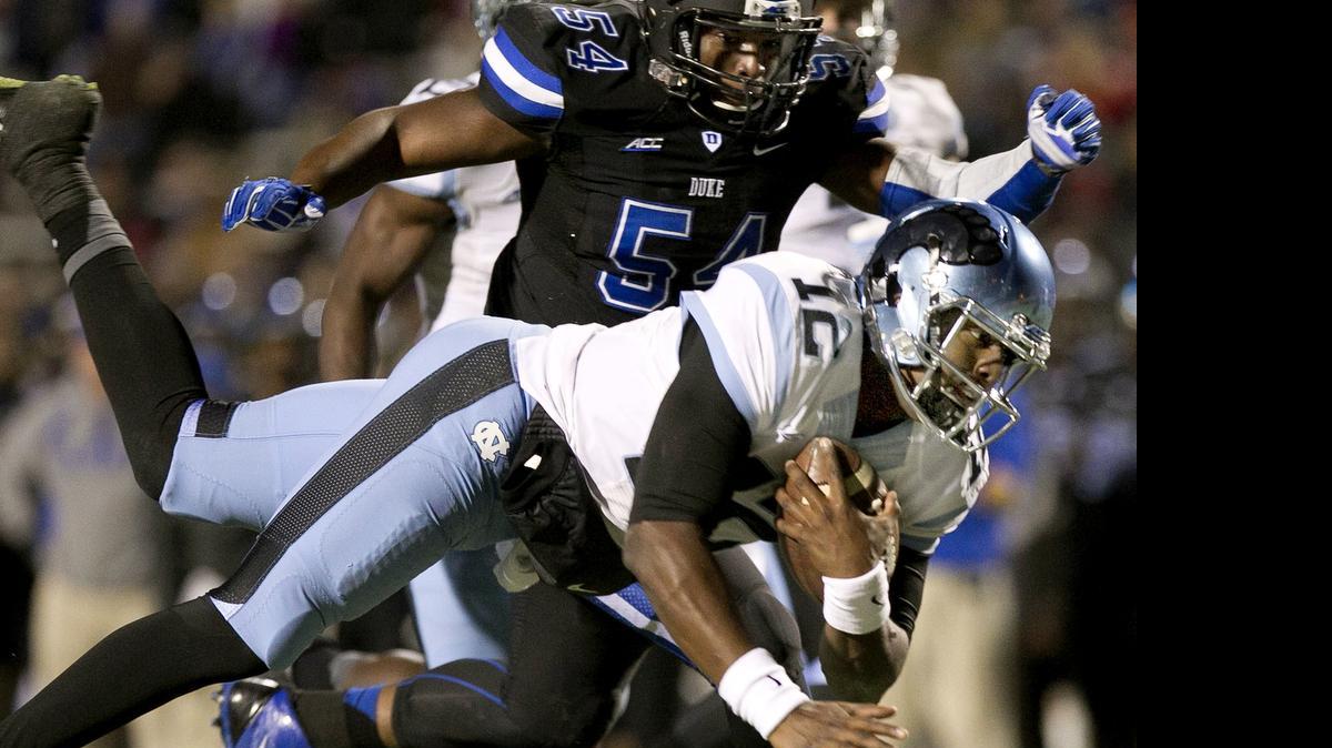
UNC quarterback Marquise Williams rushes for 12 yards to the four yard line to set up the Tar Heels' first touchdown against Duke on Thursday, November 19, 2014 at Wallace Wade Stadium in Durham,.
