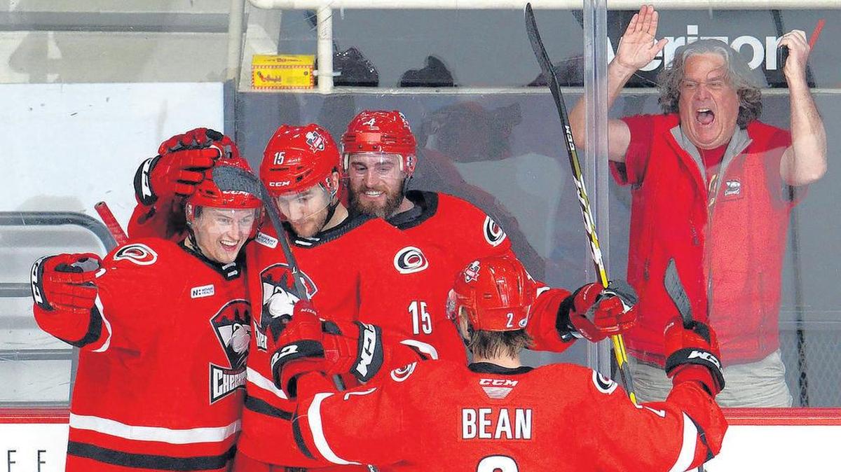 The Checkers’ Jacob Pritchard, left, and his teammates celebrate after his first-period goal in Friday’s 4-1 series-clinching win over the Providence Bruins. The goal was Pritchard’s first of his professional career.