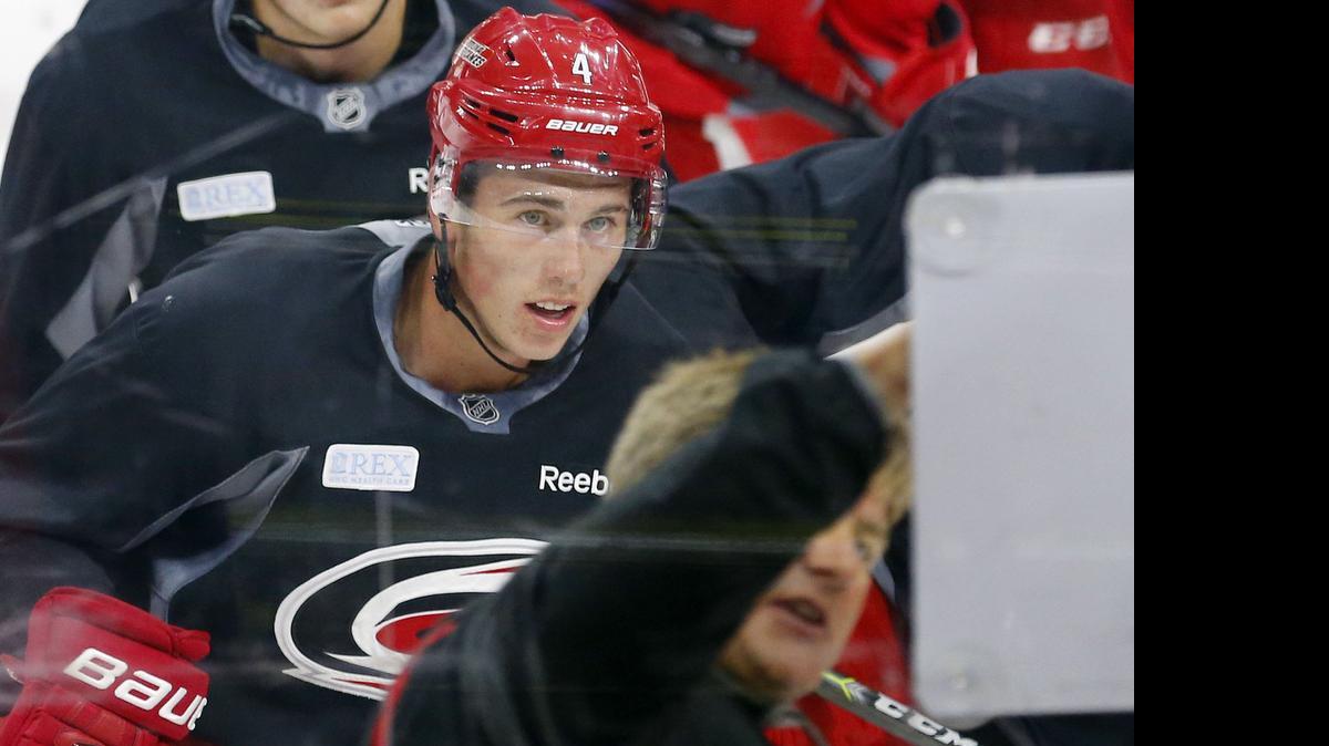 
Haydn Fleury (4) watches as head coach Bill Peters diagrams a drill as the Carolina Hurricanes hold a training camp for NHL prospects at PNC Arena in Raleigh on July 6, 2015.
