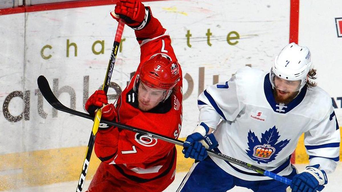 Checkers center Aleksi Saarela (7) and the Toronto Marlies’ Timothy Liljegren battle for the puck during Game 1 of the AHL Eastern Conference finals earlier this month in Charlotte. The teams return to Charlotte for Game 6 on Sunday. A Checkers win sends Charlotte to the Calder Cup Finals.