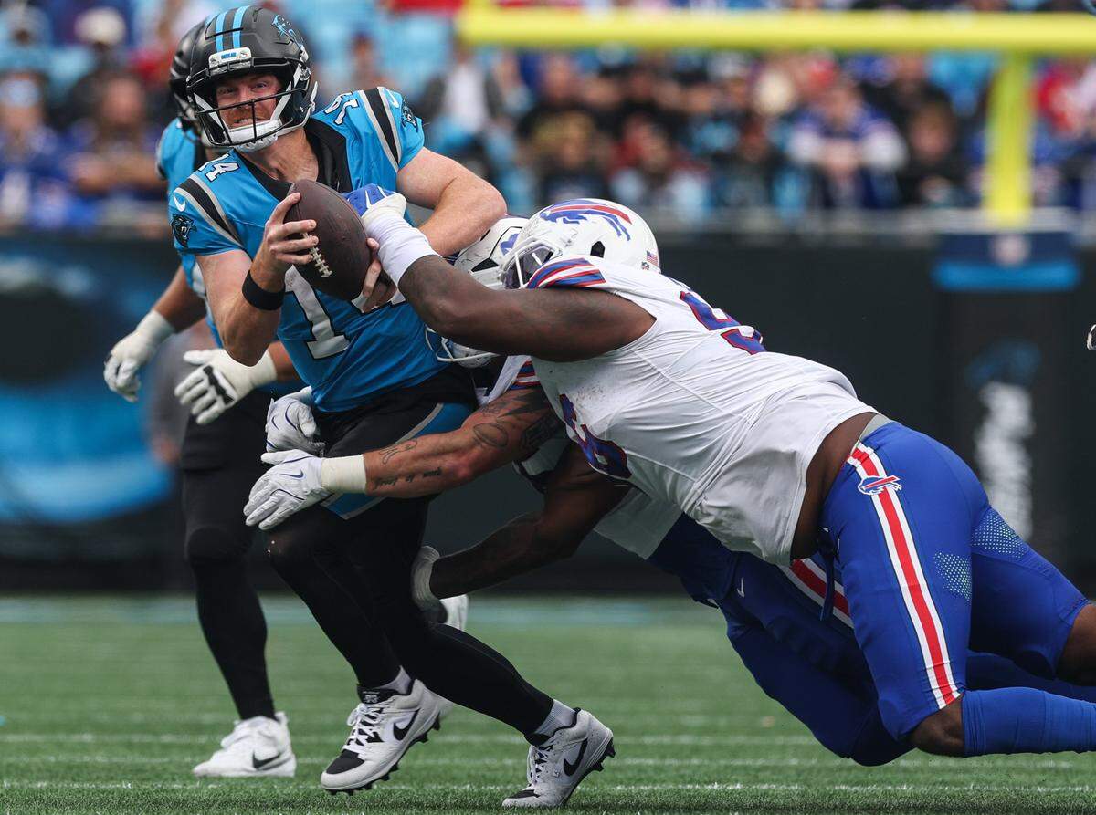 Panthers quarterback Andy Dalton gets pulled down by Bills defenders during Sunday’s game at Bank of America Stadium. Dalton was sacked seven times.