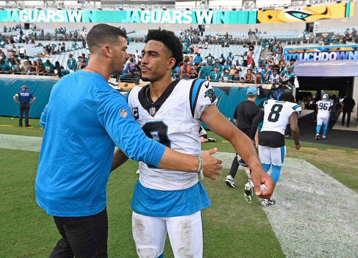 Carolina Panthers head coach Dave Canales, left, reaches out to hug quarterback Bryce Young, right, following the team’s 26-10 loss to the Jacksonville Jaguars on Sunday, September 7, 2025 at Everbank Stadium in Jacksonville, Florida.