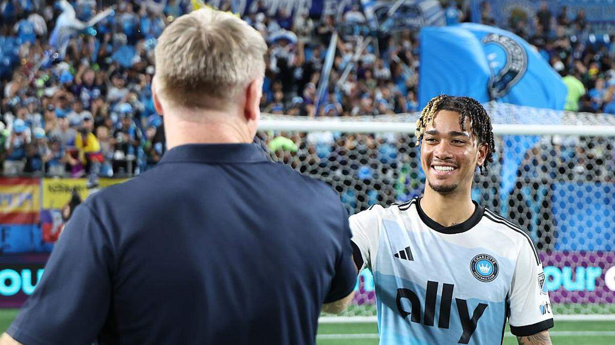CHARLOTTE, NORTH CAROLINA - SEPTEMBER 13: Idan Toklomati #17 of Charlotte FC shakes hands with Dean Smith, Head Coach of Charlotte FC, the MLS match between Charlotte FC and Inter Miami CF at Bank of America Stadium on September 13, 2025 in Charlotte, North Carolina. (Photo by David Jensen/Getty Images)