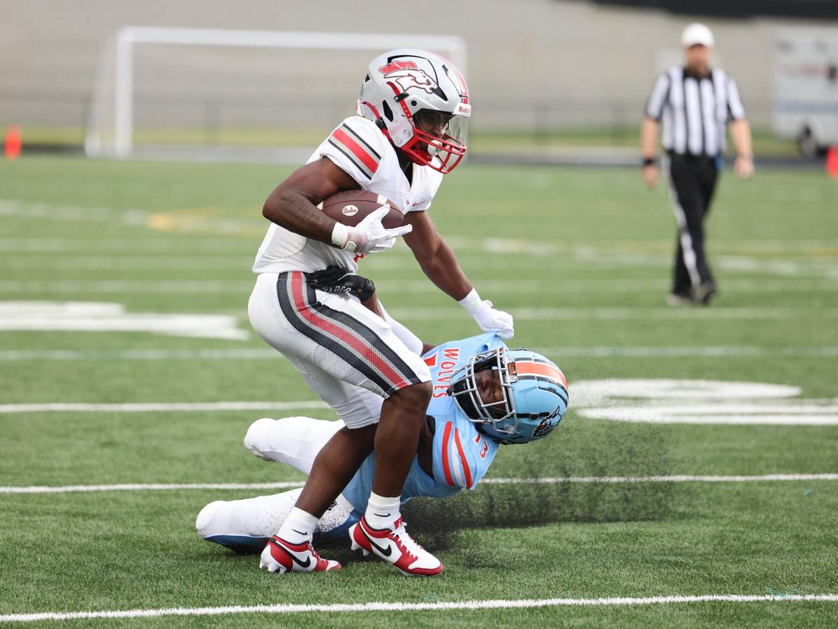 South Pointe’s Mason Pickett-Hicks holds off a Ballantyne Ridge defensive player as the Stallions take on the Wolves in Ballantyne Friday.