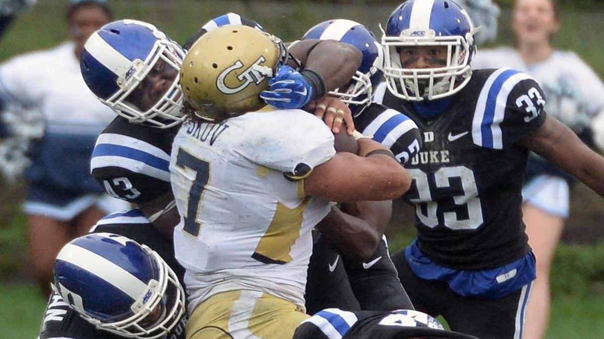 
Duke defenders linebacker's Tinashe Bere (43), and Dwayne Norman (40) stop Georgia Tech's Patrick Skov (7) in a crucial play on fourth-and-short late in the fourth quarter. 
