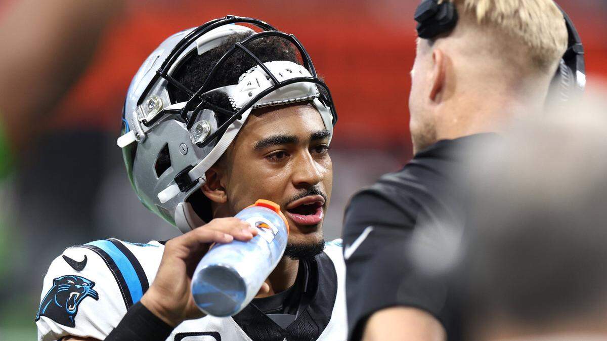 Carolina Panthers quarterback Bryce Young, left, talks with quarterbacks coach Josh McCown, right, during first half action against the Atlanta Falcons at Mercedes-Benz Stadium in Atlanta, GA on Sunday, September 10, 2023. The Falcons defeated the Panthers 24-10.