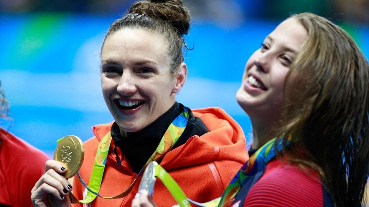 Silver medalist Kathleen Baker (right) of the United States and gold medal medalist Katinka Hosszu of Hungary pose on the podium during the medal ceremony for the Women’s 100-meter backstroke at the Rio 2016 Olympic Games in Brazil.