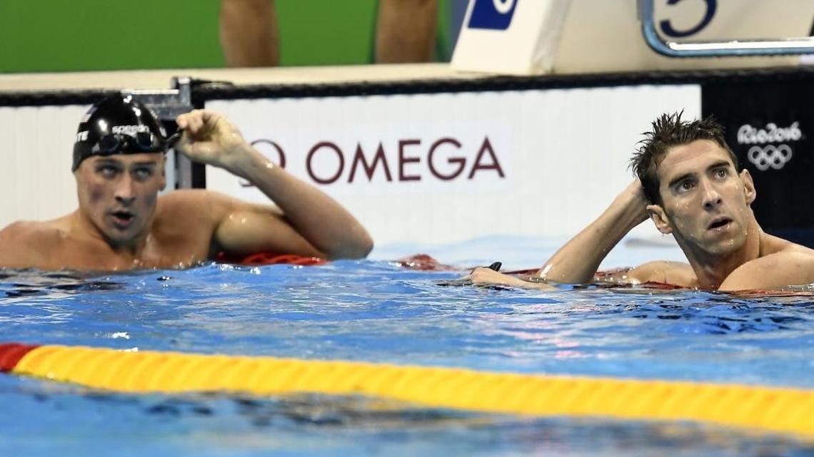 Ryan Lochte, left, and Michael Phelps check their times after competing in a men’s 200-meter individual medley semifinal Wednesday in Rio de Janeiro, Brazil. The longime friends and rivals are the top two seeds in Thursday’s 10:01 p.m. final.