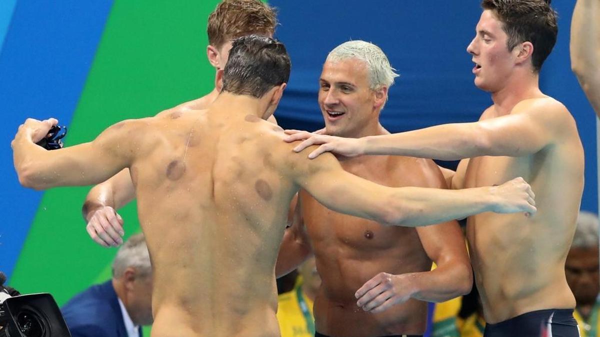 Townley Haas, left, Michael Phelps, back to camera, Ryan Lochte and Conor Dwyer, right, celebrate winning the gold medal in the men's 4x200-meter freestyle final.