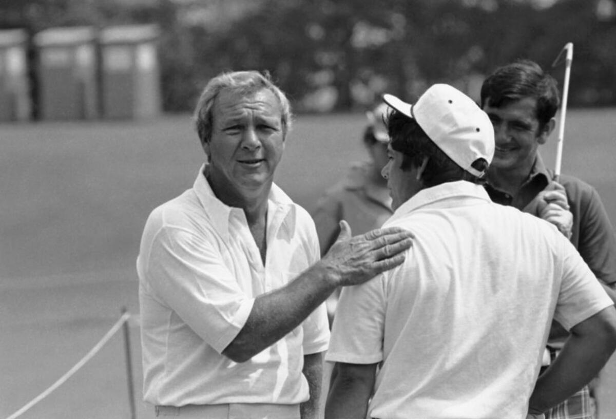 Arnold Palmer, left, greets Lee Trevino on the practice range before the first round of the 1974 PGA Championship at Tanglewood Park in Clemmons, near Winston-Salem. Trevino went on the win the major, defeating Jack Nicklaus by a stroke.