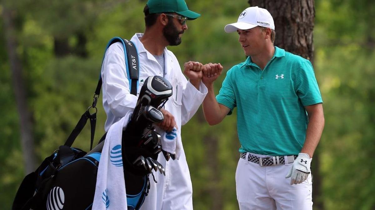 Jordan Spieth (right) fist bumps with caddie Michael Greller on the 11th hole Thursday at the Masters.