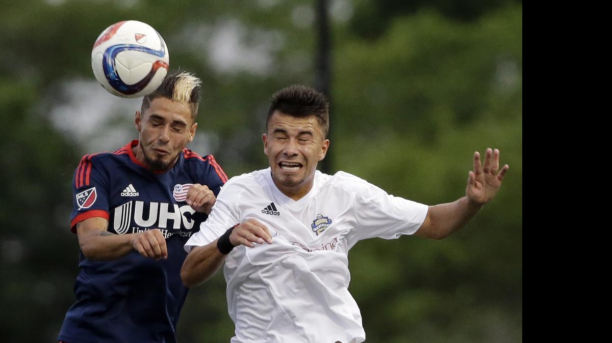 
New England Revolution forward Diego Fagundez, left, and Charlotte Independence midfielder Carlos Alvarez compete for the ball in the first half of a U.S. Open Cup soccer match Wednesday, June 17, 2015, in Boston.
