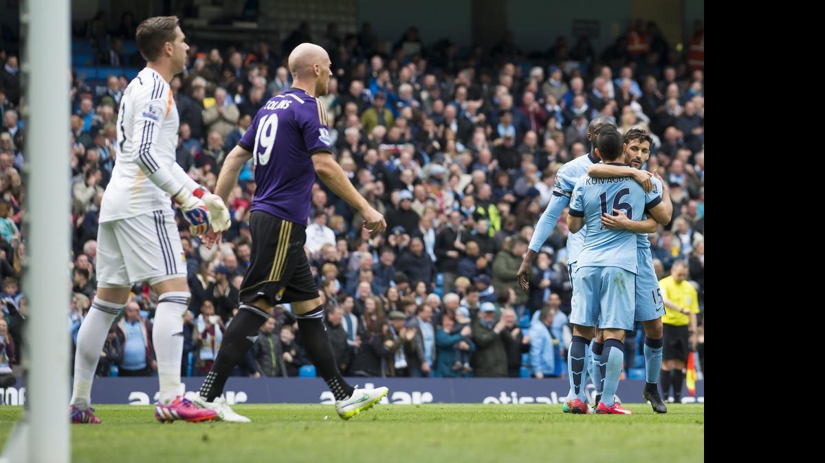 
One of the worst moments for a soccer player is scoring an own-goal. Here, Manchester City players celebrate after an own-goal by West Ham United's James Collins (second from left) during an April English Premier League soccer match.
