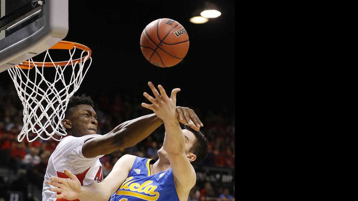 
Arizona's Stanley Johnson, left, blocks a shot by UCLA's Gyorgy Goloman during the semifinals of the Pac-12 conference tournament March 13, 2015, in Las Vegas.
