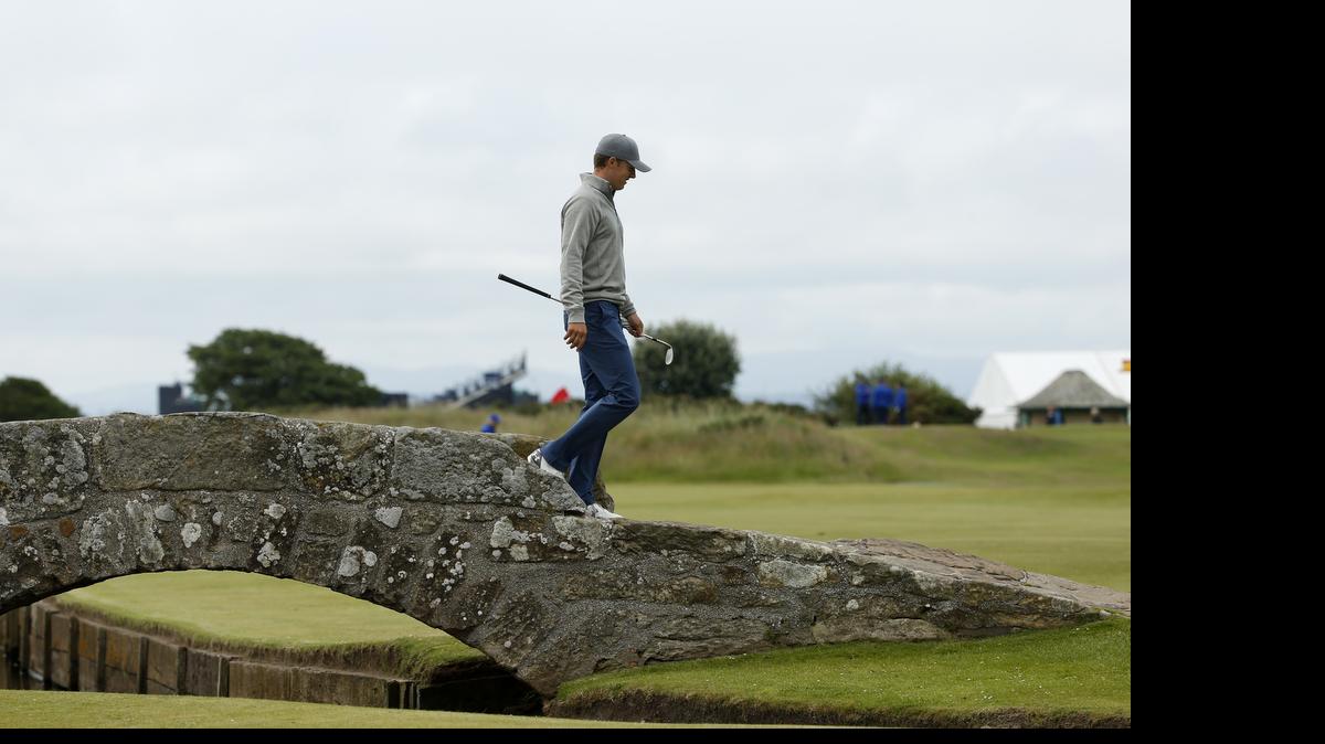 
American Jordan Spieth, the world’s No.2-ranked player, walks across Swilcan Bridge during a practice round Tuesday at the British Open. Spieth is chasing his third major this season, having won the Masters and the U.S. Open.
