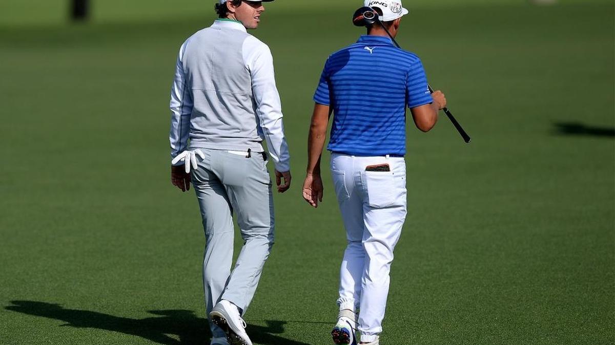 Rory McIlroy, left and Rickie Fowler, right, walk down the 16th fairway during second-round action of the Wells Fargo Championship at Quail Hollow Club on Friday. Both men, who live in Jupiter, Fla., played in front of a big gallery.