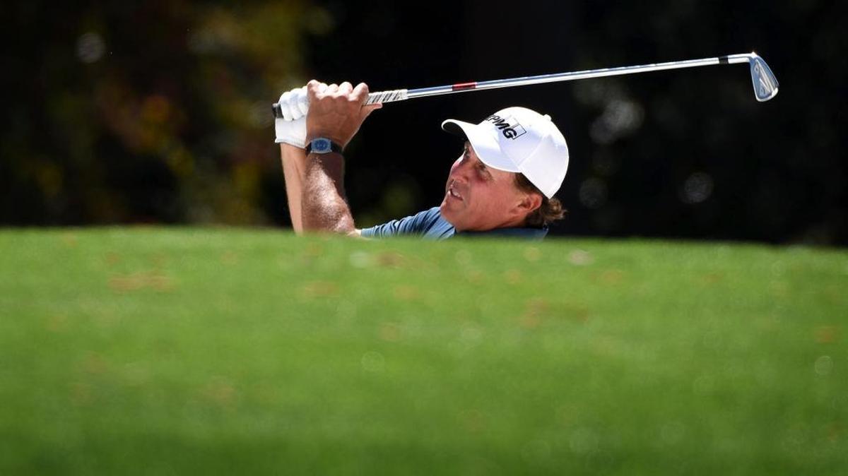 Phil Mickelson hits a shot from a sand trap along the 18th fairway during a practice round at Augusta National Golf Club in Augusta, Georgia on Tuesday.