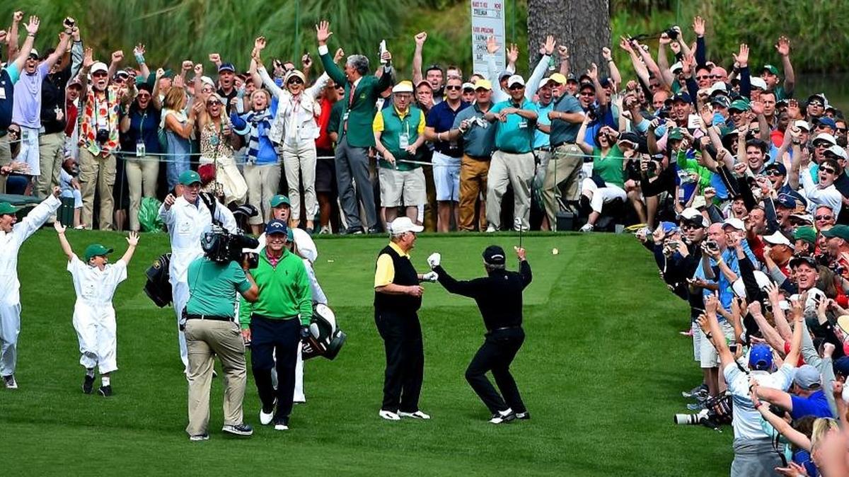 Gary Player (right) and the gallery react Wednesday to his hole-in-one at the seventh hole during the Par 3 Contest at Augusta National Golf Club.
