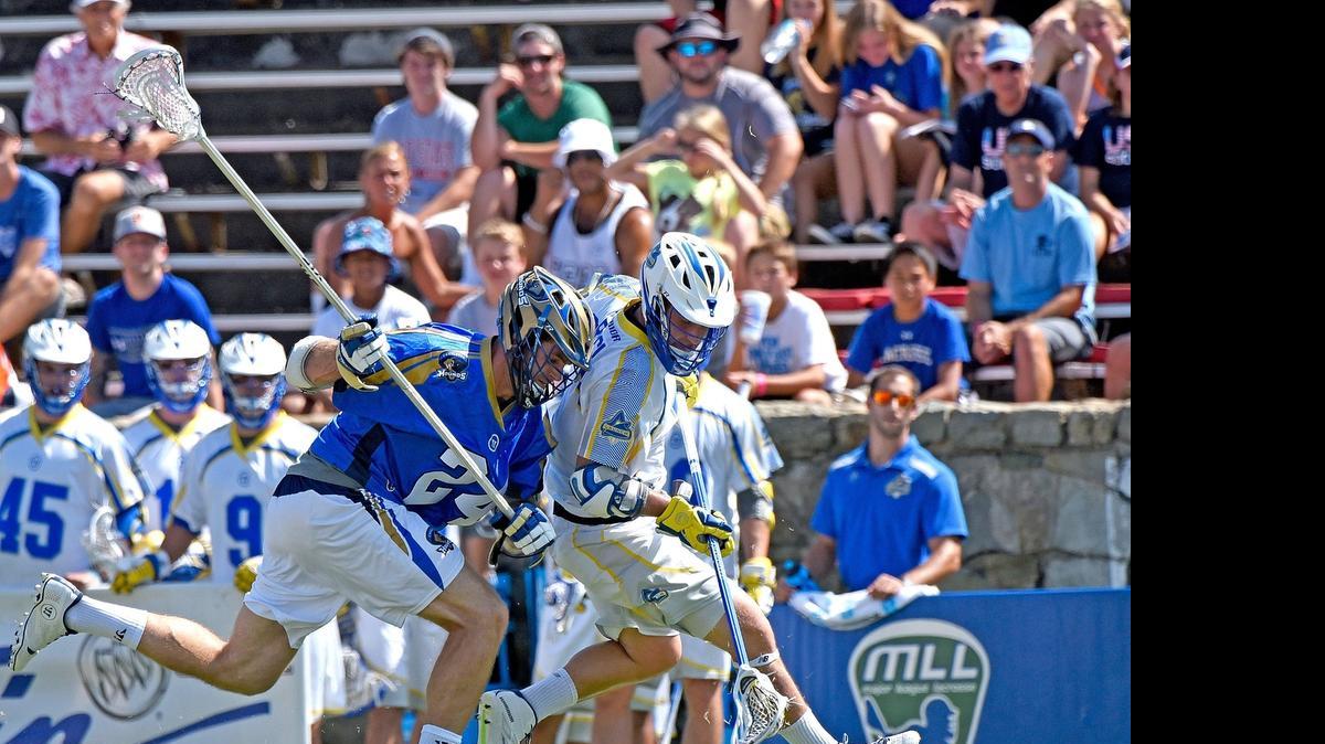 
Charlotte Hounds’ Ryan Flanagan, left, battles Florida Launch’s PT Ricci for a ground ball during their game at American Legion Memorial Stadium on Saturday in Charlotte.

