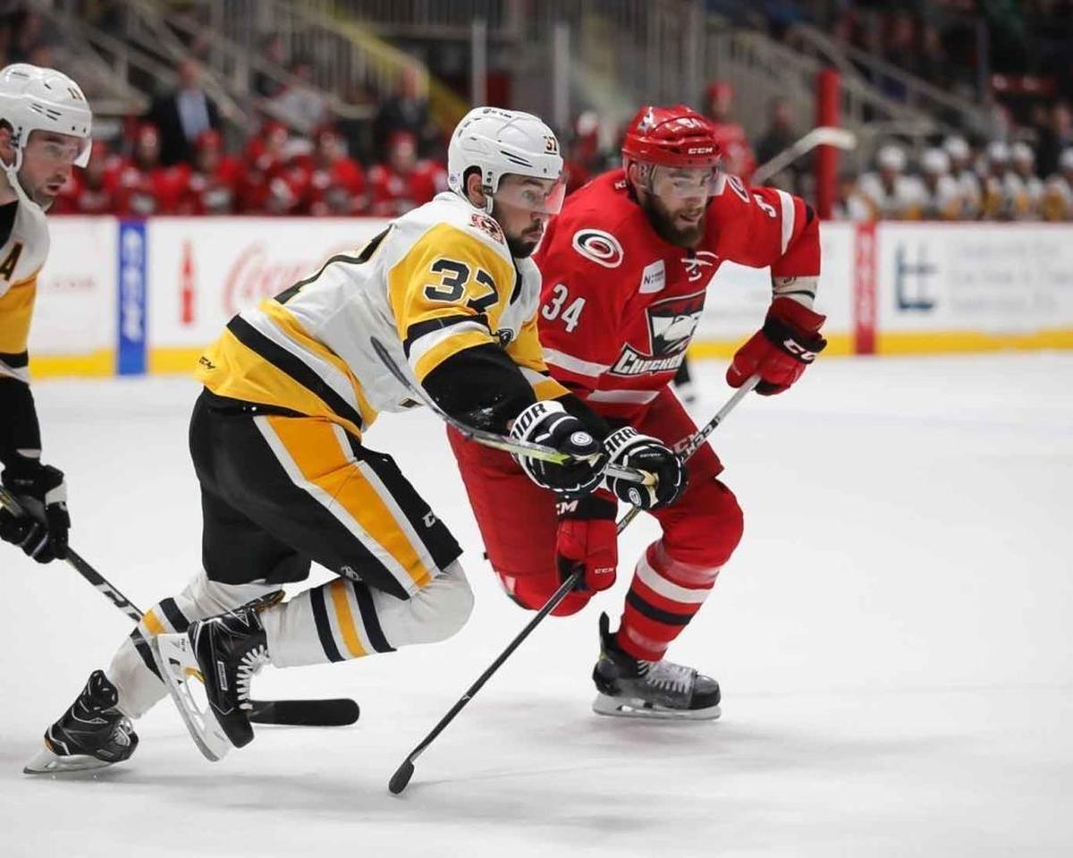 The Charlotte Checkers’ Josiah Didier, right, scored the decisive goal in Saturday’s 4-1 win over the Wilkes-Barre/Scranton Penguins in the second game of their AHL playoff series at Bojangles’ Coliseum. Above, Josiah Didier looks to secure the puck during Friday’s game.