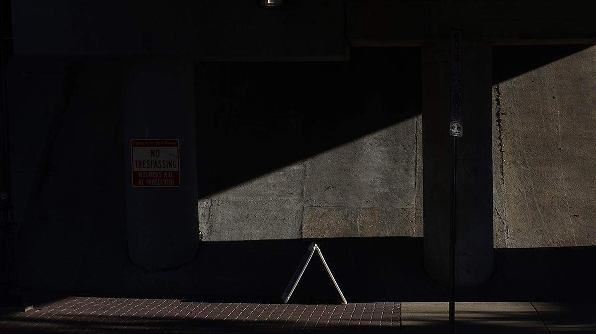 A runner goes beneath the light rail line on Fourth Street during the Thunder Road Marathon.