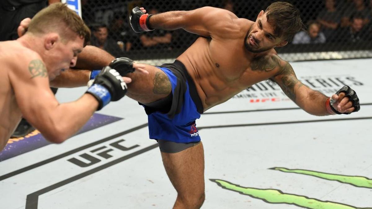 Dennis Bermudez kicks Darren Elkins in their featherweight bout during the UFC Fight Night event inside the Nassau Veterans Memorial Coliseum on July 22 in Uniondale, N.Y.