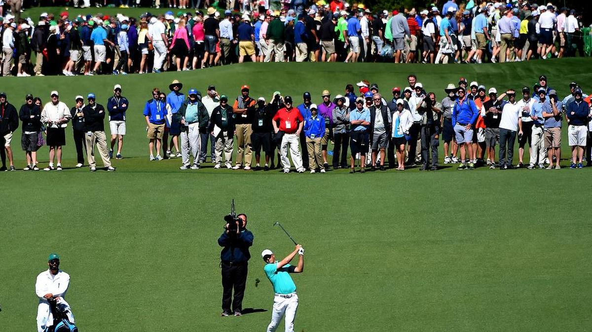 Jordan Spieth watches the flight of his second shot along with the gallery crossing the seventh fairway during first round action of The Masters Tournament on Thursday, April 7, 2016 at Augusta National Golf Club in Augusta, GA.