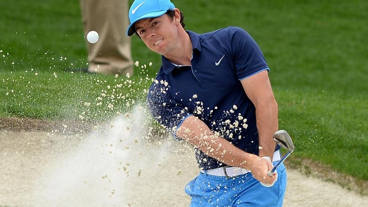 Rory McIlroy blasts from a sand trap along the fifth green during Wednesday’s pro-am at Quail Hollow Club.