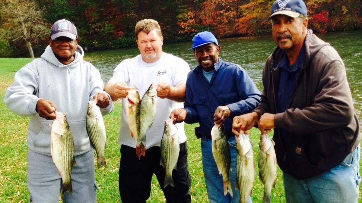 Lake Norman guide David Clubb of Mooresville, second from left, and a trio of Charlotte fishermen with their catch of Friday in the lake’s Stumpy Creek arm. Hazel Coleman, Arthur Walls and Emmanuel Cheek (from left) boated limits of hybrids and spotted bass, plus numerous white perch. “Our Thanksgiving menus will include fish!” said Walls.