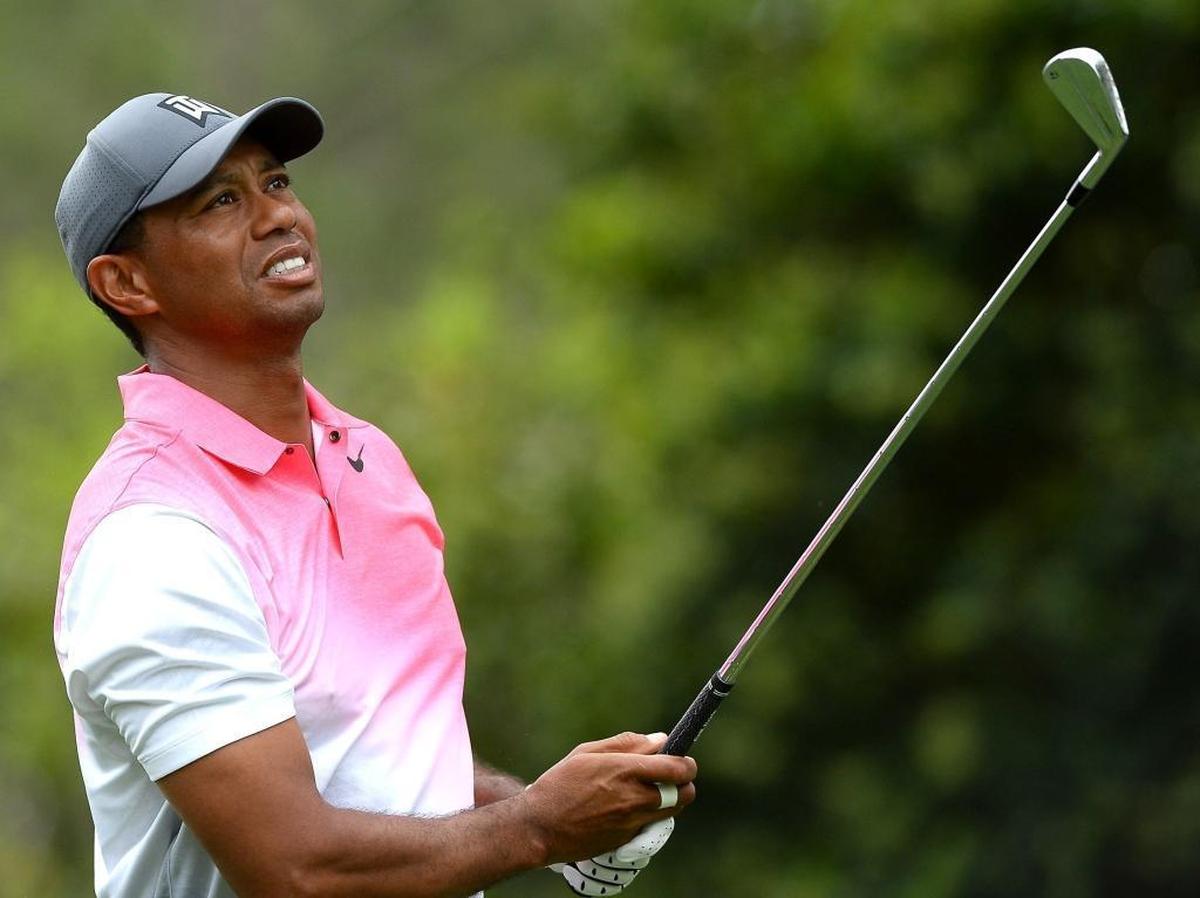 Tiger Woods watches the flight of his shot at the par-3, 249-yard No. 6 hole, where he finished with a par during Saturday’s third round of the Wells Fargo Championship at Quail Hollow.