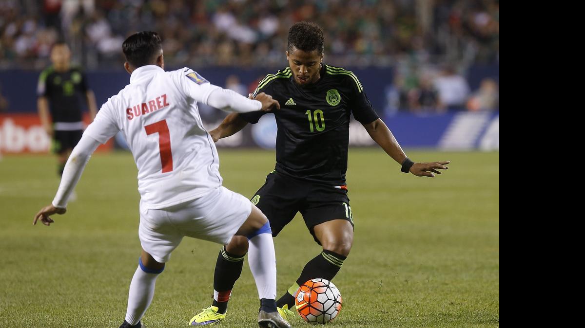 
Mexican National Team forward Giovani Dos Santos (10) fights for the ball with Cuban National Team midfielder Dario Suarez during the second half of their CONCACAF Gold Cup soccer game at Soldier Field July 9, 2015 in Chicago, Illinois. 

