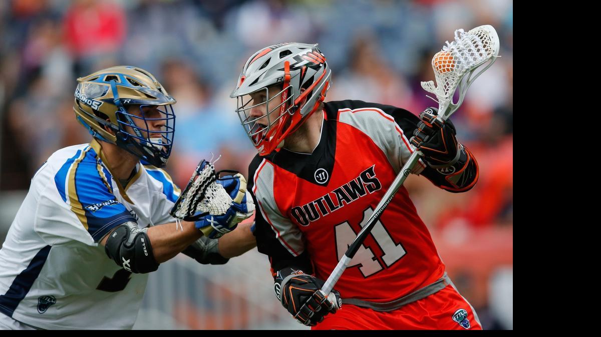 
Denver Outlaws’ Dan Taylor, right, controls the ball against Charlotte Hounds’ Jake Tripucka at Sports Authority Field at Mile High on Sunday, May 3, 2015 in Denver, Colo. The Outlaws defeated the Hounds 15-12. 
