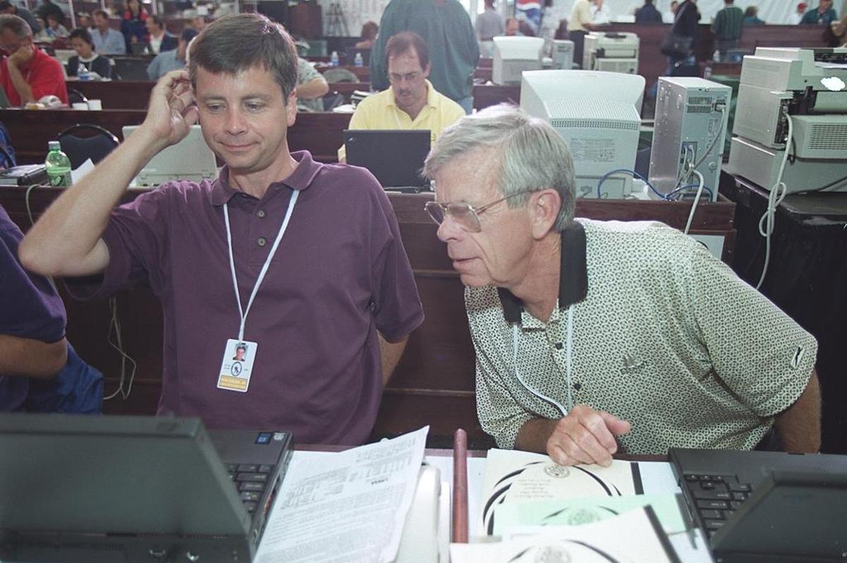 Ron Green Jr. (left) and Ron Green Sr., work in the media village for The Charlotte Observer at the 1999 U.S. Open in Pinehurst, N.C. Green Sr. retired from full-time column writing after the event, but continued to contribute occasional columns to the newspaper and covered the Masters through 2014.