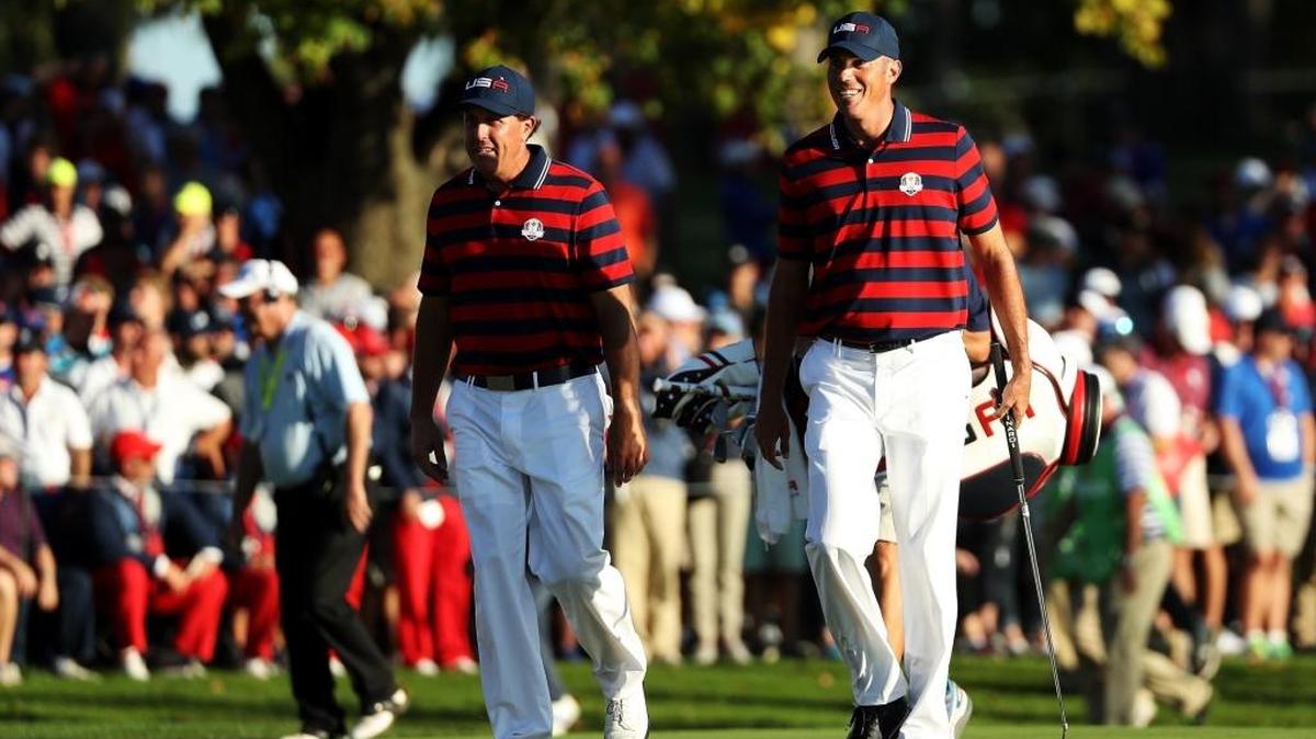 Phil Mickelson, left, and Matt Kuchar of the United States walk up the 16th hole during Saturday afternoon Ryder Cup fourball at Hazeltine National Golf Club.