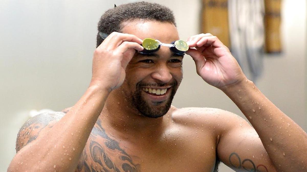 Swimmer Roy Burch, who is from Bermuda but trains in Charlotte at SwimMAC Carolinas, reached the Olympic qualifying standard in the 50-meter freestyle on Wednesday.