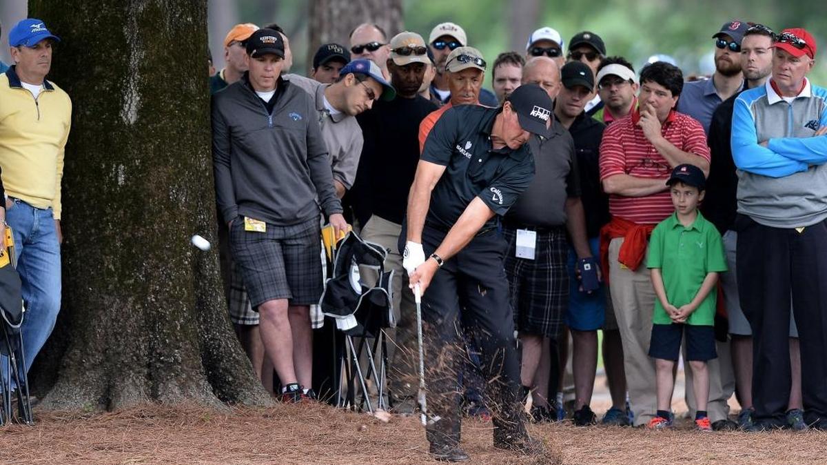 Phil Mickelson follows through on his second shot from the ninth fairway during second-round action of the Wells Fargo Championship at Quail Hollow Club.