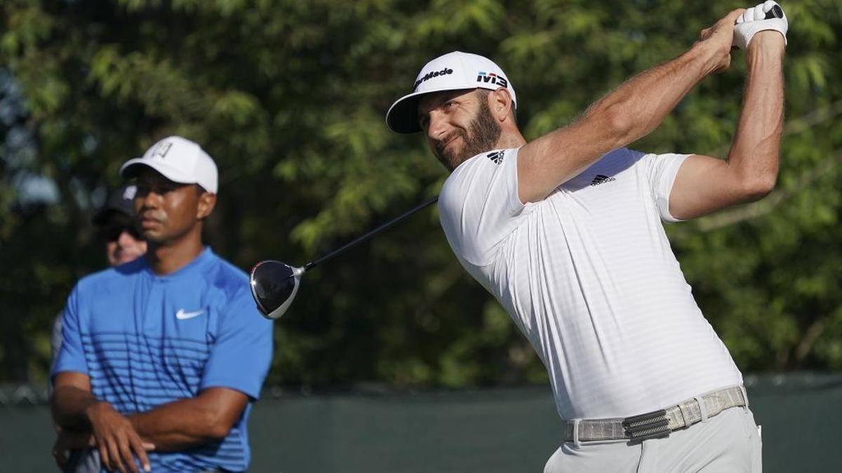 Dustin Johnson (right) reclaimed golf’s world No. 1 ranking this week and is a favorite to win the U.S. Open Championship at Shinnecock Hill Golf Club. Tiger Woods (left), healthy for the first time in years, last won the U.S. Open in 2008.