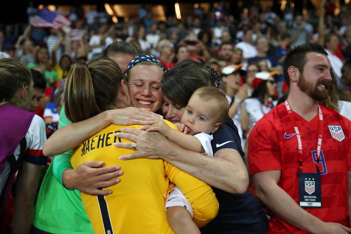 Alyssa Naeher (in yellow) is hugged by her family — from left, sisters Amanda and Abigail, mother Donna, and niece Annette, following the U.S.’s victory over France on June 28.