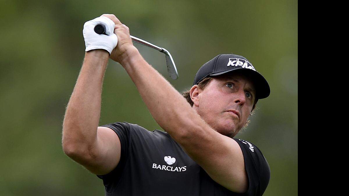 
Phil Mickelson watches his shot from the second tee during Wednesday’s Pro-Am at Quail Hollow Club, site of this week’s Wells Fargo Championship. Mickelson has played in 11 of the 12 previous tournaments in Charlotte.

