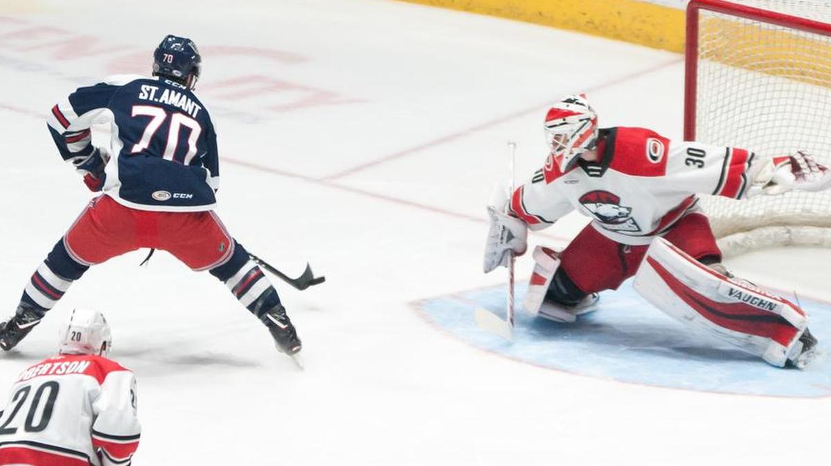 Charlotte Checkers goaltender Alex Nedeljkovic slides across the crease to make a stick-side save on a shot off the stick of Hartford Wolf Pack winger Shawn St. Amant during the first period Thursday at Bojangles’ Coliseum.