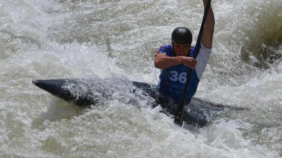 Huntersville’s Tyler Smith, 16, powers his canoe through churning whitewater Friday during U.S. Olympic team trials at the U.S. National Whitewater Center.