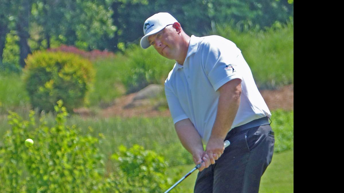 
Scott Gutschewski, of Elkhorn, Neb., chips onto the 18th green at Rocky River Golf Club in Concord, N.C., during the Wells Fargo Championship qualifying tournament on Monday.
