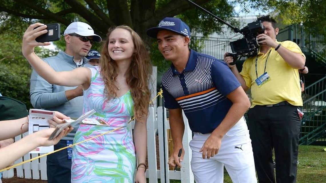 Melissa McBride, a student at N.C. State, stops Rickie Fowler, right, for a photograph during last year’s Wells Fargo Championsip at Quail Hollow Club. The club will host the 2017 PGA Championship next week.