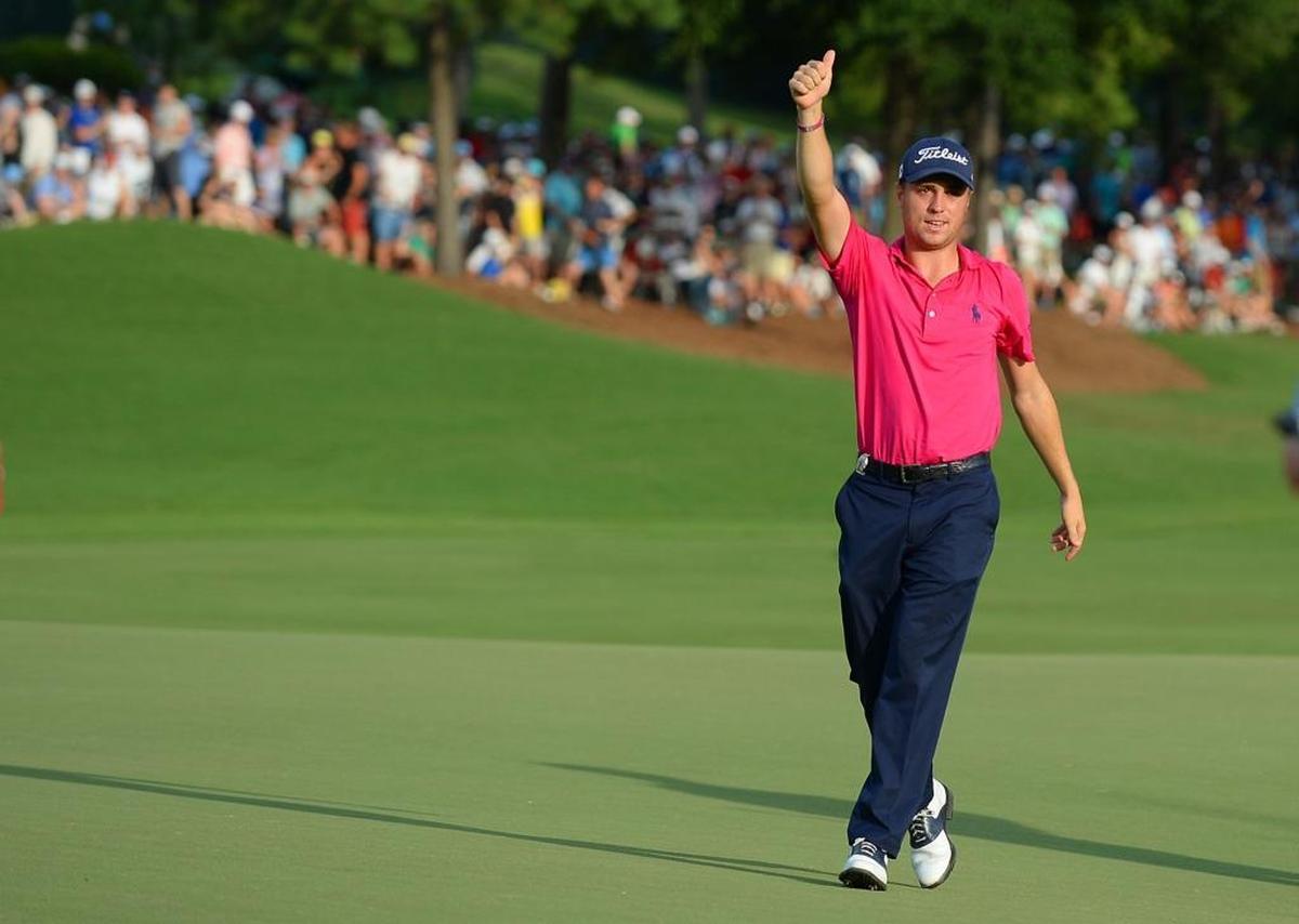 After sinking his final putt on the 18th green, Justin Thomas gives the thumbs-up to the cheering gallery at the PGA Championship at Quail Hollow Club in Charlotte.