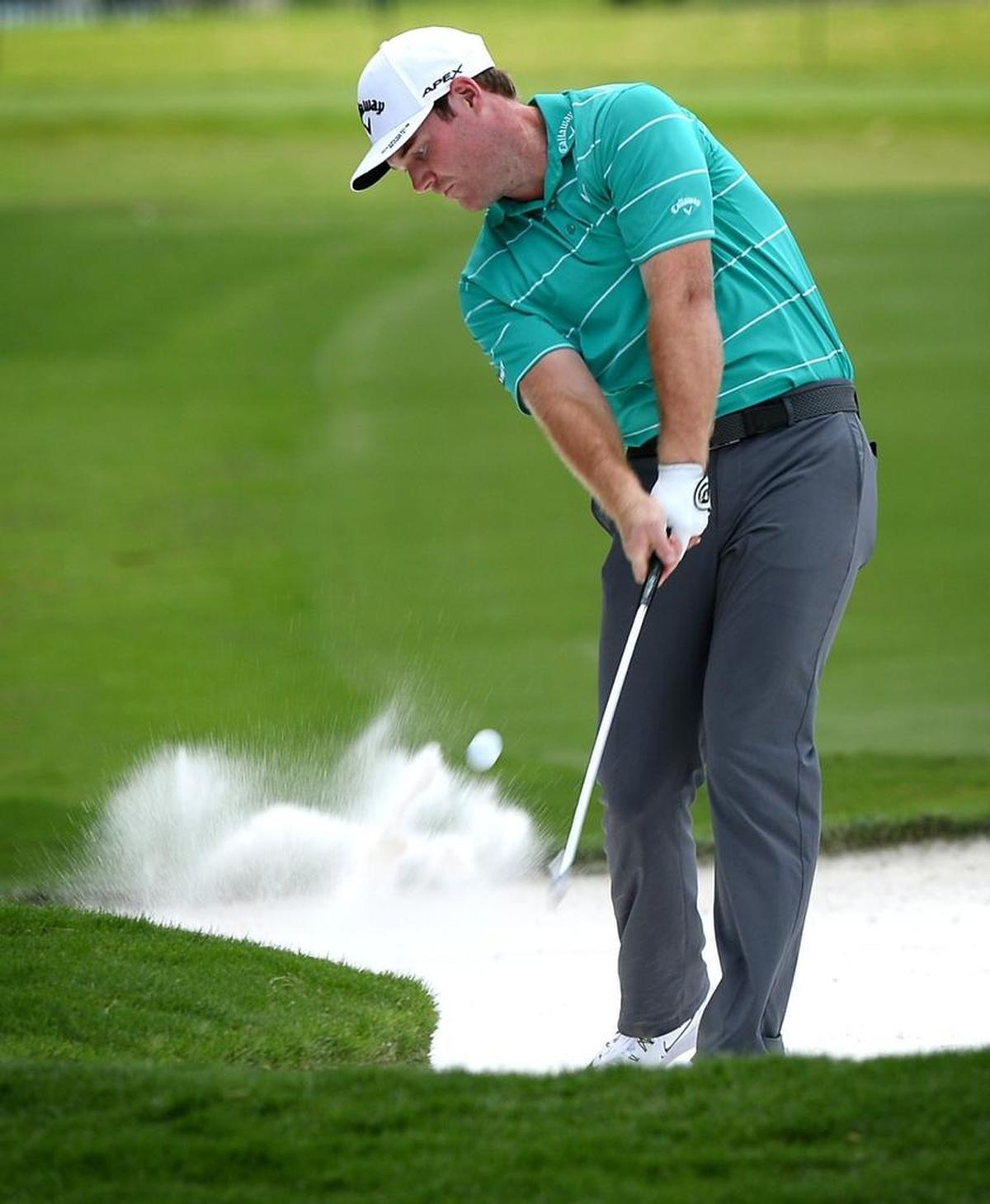Grayson Murray of Raleigh hits out of a fairway bunker during the first round of the PGA Championship at Quail Hollow Club on Thursday. Murray shot a 3-under 68 for the round.