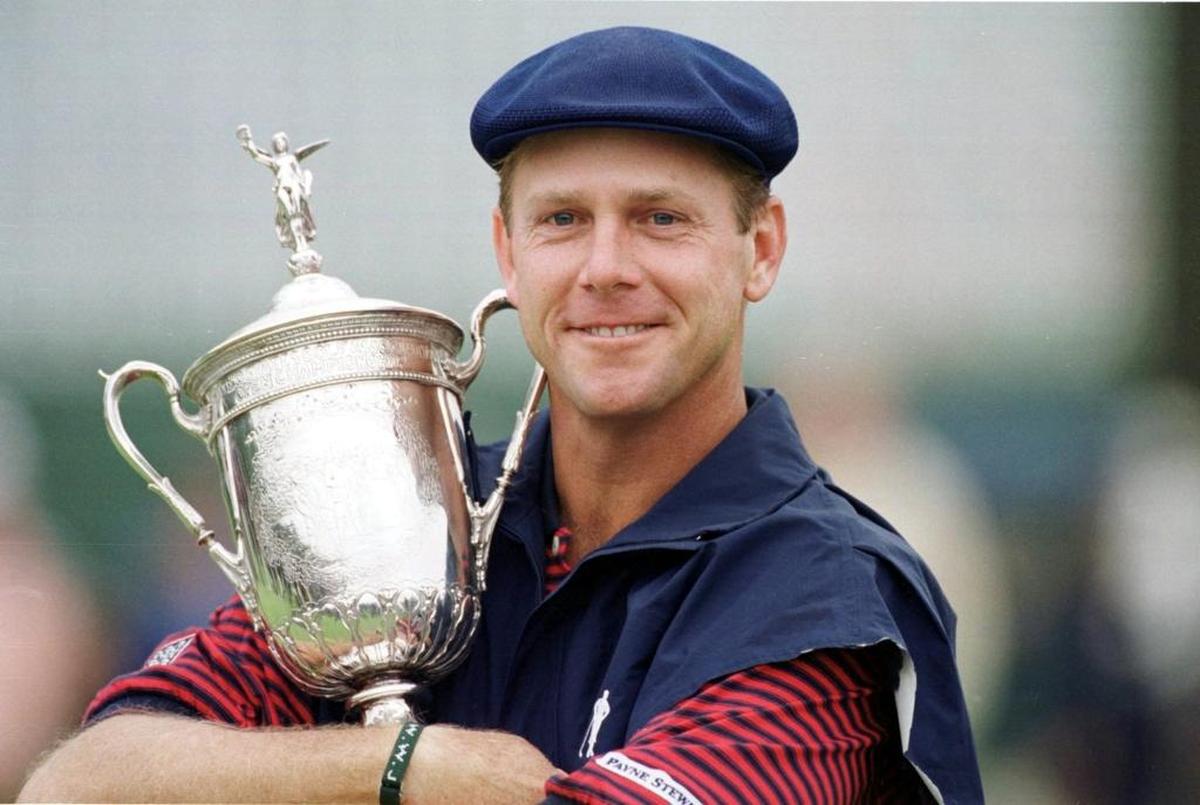 Payne Stewart, cradling his trophy for winning the 1999 U.S. Open at Pinehurst No. 2.