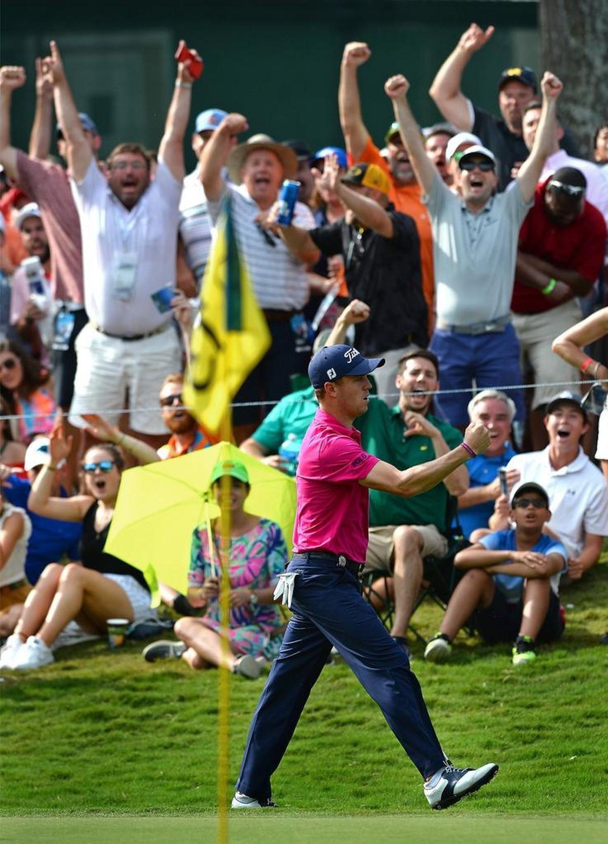 Justin Thomas and the gallery celebrate his chipping his ball into the cup on the 13th green during Sunday’s final round of the PGA Championship at Quail Hollow Club in Charlotte.